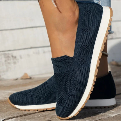 Black slip-on knitted shoes with a white sole